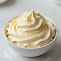 To make this vanilla buttercream frosting, you need a few key items. Here&rsquo;s what you&rsquo;ll need: - 1 cup unsalted butter, softened to room temperature - 4 cups powdered sugar, sifted for a smoother texture - 1/4 cup heavy cream, chilled - 2 teaspoons pure vanilla extract - A pinch of fine sea salt Using high-quality ingredients makes a big difference. I recommend using unsalted butter for a clean taste. Pure vanilla extract adds rich flavor. Always sift your powdered sugar to avoid lumps. For cream, heavy cream gives the best texture. You can add fun elements to your frosting. Consider these optional ingredients: - Food coloring for a fun twist - Sprinkles for decoration - Flavored extracts, like almond or lemon, for a unique taste These extras allow you to make your frosting special and personalized! {{ingredient_image_2}} Start by placing 1 cup of softened unsalted butter in a large bowl. Beat the butter with an electric mixer at medium speed. Mix for about 2-3 minutes. The butter should become creamy and smooth. It will lighten in color, which is a good sign. Next, add 4 cups of sifted powdered sugar. Do this one cup at a time. Mix on low speed after each addition. This helps avoid a sugary mess. Remember to scrape down the bowl's sides. This ensures all the sugar gets mixed in well. Once all the sugar is in, pour in 1/4 cup of chilled heavy cream. Then, add 2 teaspoons of pure vanilla extract and a pinch of fine sea salt. This mix gives your frosting its rich flavor. Now, increase the mixer speed to medium-high. Whip the frosting for 3-5 minutes. You want it to become light and fluffy. If you like, add a few drops of food coloring for a fun touch. Mix on low speed until the color spreads evenly. Taste the frosting and adjust sweetness or vanilla to your liking. Use right away or store in the fridge. Re-whip it to make it fluffy again when needed. To get that dreamy, fluffy texture, start with softened butter. Beat it well for 2-3 minutes. This step is key. Then, add the powdered sugar slowly, one cup at a time. Mixing on low speed helps avoid a sugary cloud. After adding the cream and vanilla, whip the mixture for 3-5 minutes. This will make your frosting light and airy, perfect for spreading or piping. A few common mistakes can ruin your frosting. First, don&rsquo;t skip the sifting step for powdered sugar. It helps create a smooth texture. Second, avoid adding too much cream at once. This can make your frosting too runny. Lastly, don&rsquo;t forget to scrape down the bowl. This ensures all ingredients mix well and your frosting is uniform. You can easily adjust the flavor to suit your taste. If you want it sweeter, add more powdered sugar. For a stronger vanilla taste, add a bit more pure vanilla extract. You can also try adding a hint of almond extract for a new twist. If you're feeling adventurous, mix in some cocoa powder for a chocolate flavor. Want color? A few drops of food coloring can brighten things up! Pro Tips Room Temperature Butter: Ensure your butter is truly at room temperature for the best results. It should be soft enough to leave an indentation but not melted, as this affects the texture of your frosting. Sifting Powdered Sugar: Always sift your powdered sugar before adding it to the butter. This helps eliminate lumps and ensures a smooth, creamy frosting. Heavy Cream Substitute: If you don&rsquo;t have heavy cream, you can substitute with milk or half-and-half, but the frosting may be slightly less rich and creamy. Frosting Consistency: If your frosting is too thick, add a little more heavy cream, one tablespoon at a time, until you achieve your desired consistency. If it&rsquo;s too thin, gradually add more powdered sugar. {{image_4}} You can change the taste of your vanilla buttercream frosting easily. Just swap out some ingredients! For a chocolate twist, mix in &frac12; cup of cocoa powder when adding the powdered sugar. This gives your frosting a rich, chocolatey flavor. If you love almond, use almond extract instead of vanilla. A teaspoon of almond extract can add a nutty taste that pairs well with many desserts. You can also try adding a few drops of peppermint extract for a fresh flavor. It works great on holiday treats! Adding color to your frosting can be fun and easy! Start with gel food coloring instead of liquid. Gel colors give a brighter hue with less liquid. To make pastels, add a tiny bit of gel. Mix it in slowly until you reach the desired shade. For bold colors, add more gel food coloring. You can also create fun patterns. Use a piping bag with different colors to swirl them together. This makes your cupcakes or cakes pop! This vanilla buttercream frosting pairs well with many treats. Use it on classic vanilla or chocolate cupcakes for a sweet touch. You can also spread it on cookies or brownies. It adds a creamy layer that makes each bite special. Try it on a layer cake with fresh fruit between the layers. Strawberries or raspberries add a nice contrast to the sweet frosting. Let your imagination run wild! The options are endless. To store your vanilla buttercream frosting, place it in an airtight container. This keeps it fresh and prevents any odors from other foods in the fridge. Make sure the container is clean and dry before adding the frosting. You can also press a piece of plastic wrap directly onto the frosting's surface to avoid any crust forming. When stored properly, your vanilla buttercream frosting can last up to two weeks in the fridge. If you freeze it, it can last for about three months. Just remember that the texture may change slightly after freezing, so re-whipping is key. When you&rsquo;re ready to use the chilled frosting, take it out of the fridge. Let it sit at room temperature for about 10-15 minutes. Then, use an electric mixer on medium speed to re-whip the frosting for a few seconds. This helps restore its light and fluffy texture. If it feels too thick, add a splash of heavy cream to loosen it up. Enjoy your perfectly whipped frosting on cakes or cupcakes! Yes, you can use margarine in place of butter. This change will alter the taste slightly. Margarine often has more water, which can make the frosting softer. If you use margarine, try to pick a stick form. It usually works best for frosting. To make vegan frosting, you can use vegan butter or coconut cream. These substitutes will give you a nice texture. Replace heavy cream with almond milk or a nut-based option. Ensure your vanilla extract is also alcohol-free for the best results. If your frosting is too runny, add more powdered sugar. Start with a small amount, about 1/4 cup. Mix well and check the consistency. If it is still too runny, add more sugar slowly until it thickens. You can also chill the frosting for a short time to help firm it up. This blog post shared essential ingredients and proper mixing steps for the perfect frosting. You learned how to avoid mistakes and make flavor tweaks. I also covered fun variations and storage tips to keep frosting fresh. Remember, each step counts in creating a delicious treat. With practice, you can master these techniques and impress family and friends. Enjoy experimenting and making your desserts extra special!