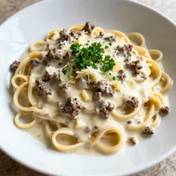 - 8 oz (225 g) fettuccine or penne pasta - 1 lb (450 g) ground beef - 1 medium onion, finely chopped - 3 cloves garlic, minced - 1 cup (240 ml) heavy cream - 1/2 cup (120 ml) beef broth - 1/2 cup (50 g) finely grated Parmesan cheese - 1 tablespoon extra virgin olive oil - 1 teaspoon Italian seasoning blend - Salt and freshly ground pepper to taste - Fresh parsley, finely chopped (for garnish) To make creamy beef pasta, you need a few key ingredients. First, choose your pasta. I like fettuccine or penne for this dish. They hold the sauce well and add a nice bite. Next, ground beef is the star of the show. Use fresh beef for the best flavor. Aromatics like onion and garlic add depth. Chop the onion finely and mince the garlic for even cooking. For the creamy sauce, heavy cream is a must. It gives the dish richness. Add beef broth for extra flavor and a smooth texture. Seasonings are important too. Italian seasoning brings warmth, while salt and pepper enhance all the flavors. Lastly, don't forget the garnish. Fresh parsley adds color and a fresh taste. A sprinkle of grated Parmesan cheese on top makes it even more delicious. With these ingredients, you're ready to create a creamy beef pasta that will impress everyone! {{ingredient_image_2}} - Bring a large pot of salted water to a boil. - Add 8 oz of fettuccine or penne. - Cook the pasta for 8-10 minutes until al dente. - Reserve about 1/2 cup of cooking water. - Drain the pasta and set it aside. To get the perfect pasta texture, you want it firm but not hard. Al dente means "to the tooth." It should have a nice bite. - In a large skillet, heat 1 tablespoon of olive oil over medium heat. - Add 1 medium chopped onion and 3 minced garlic cloves. - Saut&eacute; for about 3-4 minutes until soft and fragrant. Next, increase the heat to medium-high. Add 1 lb of ground beef. Cook it for 6-8 minutes, breaking it apart as it cooks. The beef should be brown and not pink. If you see excess fat, drain it off. - Lower the heat to medium. Pour in 1 cup of heavy cream and 1/2 cup of beef broth. - Stir well to mix everything together. Let the sauce simmer for a few minutes. This helps it thicken. You want a nice creamy texture. - Add the drained pasta into the skillet with the sauce. - Toss everything together until well coated. If the sauce feels too thick, add some of the reserved pasta water. This helps you reach the perfect consistency. Enjoy the creamy goodness! To ensure ideal pasta texture, always cook it until al dente. This means the pasta should still have a slight bite. If you overcook it, the pasta can turn mushy. A good tip is to taste it a minute before the package time is up. To prevent a greasy sauce, drain excess fat after browning the beef. If there's too much fat, it can make your sauce oily. Use a spoon to remove it carefully. For extra flavor, consider adding fresh herbs like basil or thyme. A splash of Worcestershire sauce can also add depth. These small tweaks can elevate your dish. Adjust seasoning to taste by starting with small amounts of salt and pepper. Taste your sauce before serving. This way, you can find the perfect balance. The best cookware for this recipe is a large skillet. It lets you cook the beef and sauce evenly. A pot for boiling pasta is essential, too. Useful tools for preparation include a wooden spoon for mixing and a sharp knife for chopping. A measuring cup for the cream and broth will help you get the right amounts every time. Pro Tips Cook Pasta Al Dente: Make sure to cook the pasta until it's al dente for the best texture. This will prevent the pasta from becoming mushy when mixed with the creamy sauce. Use Fresh Ingredients: Whenever possible, opt for fresh garlic and herbs. Fresh ingredients will enhance the flavor of your dish and make it more aromatic. Adjust Sauce Consistency: If your sauce is too thick, gradually add the reserved pasta water to achieve the desired creaminess without watering it down. Garnish for Flavor: Don't skip the fresh parsley! It not only adds a pop of color but also a fresh flavor that complements the richness of the creamy sauce. {{image_4}} You can switch out the ground beef for other proteins. Chicken or turkey works well in this dish. These meats still give a great flavor and keep it light. If you prefer a dairy-free option, use coconut cream instead of heavy cream. It adds a unique twist while making it safe for those with dairy allergies. Try adding fresh vegetables to your pasta. Spinach or mushrooms add great taste and nutrition. You can also change the cheese you use. For example, goat cheese or cheddar can give your dish a different flavor profile. Experimenting with these options can make your creamy beef pasta even more special. Pair your creamy beef pasta with a fresh salad. A simple green salad with vinaigrette balances the richness of the dish. For drinks, a light red wine, like Pinot Noir, complements the flavors well. If you want a non-alcoholic option, try sparkling water with lemon. To store leftovers, let the creamy beef pasta cool to room temperature. Place it in an airtight container. This keeps moisture in and prevents drying out. Store it in the fridge for 3 to 4 days. Use glass or plastic containers with tight-fitting lids for best results. To freeze creamy beef pasta, first cool it completely. Then, scoop portions into freezer-safe bags or containers. Remember to leave some space for expansion. This dish can last in the freezer for up to 3 months. For thawing, move it to the fridge for a few hours or overnight. Reheat it in a skillet over low heat. Add a splash of broth or cream if it seems dry. Stir frequently to warm evenly. Enjoy your delicious pasta even after storing! How can I make creamy beef pasta spicy? To add some heat, use red pepper flakes. Start with 1/4 teaspoon and increase to your taste. You can also add diced jalape&ntilde;os or a dash of hot sauce. For a smoky touch, try smoked paprika. These options will give your dish a nice kick without overpowering the creamy flavor. Can I use whole wheat pasta instead? Yes, whole wheat pasta works well. It adds a nutty flavor and a bit more fiber. Just remember that whole wheat pasta may take a minute or two longer to cook. Check the package for timing, and taste it to ensure it's al dente. Caloric content per serving Each serving has about 550 calories. This includes the pasta, beef, cream, and cheese. It's a filling dish, perfect for a hearty meal. Protein and carb breakdown One serving contains roughly 30 grams of protein. The carbohydrates are around 60 grams per serving. This balance makes it a great option for energy after a long day. Tips for scaling the recipe If you want to make more, just double the ingredients. Keep the same cooking times for pasta and sauce. This keeps the flavors balanced and tasty. Adjustments for cooking larger batches For larger batches, use a bigger pot for pasta. A larger skillet helps to mix the sauce and meat better. You might need to adjust the heat to ensure even cooking. Always taste as you go to maintain flavor. This blog post covers how to make creamy beef pasta from start to finish. We explored ingredients, cooking steps, and helpful tips. You can use different types of pasta and proteins, plus add vegetables for more flavor. Remember to store leftovers properly to enjoy later. Try these steps in your next meal and make it your own. With practice, you'll master this dish and impress everyone at the table. Happy cooking!