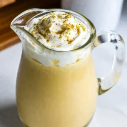 - 2 cups whole milk - 1 cup heavy cream - 3/4 cup granulated sugar - 4 large eggs - 1 tablespoon vanilla bean paste or 1 vanilla bean - 1/2 teaspoon ground nutmeg - 1/4 teaspoon ground cinnamon - Whipped cream for garnish - Ground nutmeg or cinnamon for garnish For a perfect Vanilla Bean Eggnog Cocktail, you need simple ingredients. Start with whole milk and heavy cream for that creamy base. The sugar adds sweetness, while eggs give it richness. Vanilla bean paste or a fresh vanilla bean brings a lovely flavor. Don't forget the nutmeg and cinnamon for warmth. Finally, whipped cream and a sprinkle of spices make it festive. These ingredients combine to create a delightful drink that warms the heart. {{ingredient_image_2}} - Gently combine 2 cups of whole milk and 1 cup of heavy cream in a saucepan. - Heat on low and stir often to avoid boiling. This step is key. Heating slowly helps flavors mix. You don&rsquo;t want a burnt taste. - Vigorously whisk together 4 large eggs and 3/4 cup of granulated sugar until the mix is pale and fluffy. This makes a light custard. It adds air, which makes your eggnog creamy and rich. - Slowly incorporate the warm milk and cream into your egg mixture. - Whisk continuously to temper the eggs. This keeps them from scrambling. Next, return the tempered mix to the saucepan. Cook on low heat, stirring constantly until it thickens. This takes about 5 to 8 minutes. - Stir in 1 tablespoon of vanilla bean paste, 1/2 teaspoon of ground nutmeg, and 1/4 teaspoon of ground cinnamon. Let the warm flavors meld together. Once thickened, cool the mix to room temperature. After cooling, pour the eggnog into a pitcher. Cover and refrigerate for at least 2 hours. This helps flavors develop. When ready to serve, pour the chilled eggnog into frosty glasses. Top each glass with whipped cream and a sprinkle of nutmeg or cinnamon. Enjoy this luscious holiday delight! To make the best eggnog, you must temper the eggs. This means adding warm milk to the eggs slowly. If you add the milk too fast, the eggs will cook and scramble. Instead, whisk the eggs while you pour in the warm milk. This keeps the mixture smooth and creamy. When cooking the mixture, keep the heat low. Stir it constantly with a wooden spoon. You want it to thicken slightly, not boil. It should coat the back of the spoon, leaving a clear trail when you run your finger through it. Serve your eggnog in frosty glasses. This keeps it cold and refreshing. Top each glass with a generous dollop of whipped cream. Then, sprinkle ground nutmeg or cinnamon on top. This adds an aromatic touch that enhances the flavor. For a festive look, use glass mugs. They add charm to your holiday table. You can also add a cinnamon stick as a stirrer. This not only looks nice but also gives a hint of extra spice with each sip. Pro Tips Use Fresh Ingredients: For the best flavor, use fresh eggs and high-quality vanilla bean paste or beans. Fresh ingredients elevate the taste of your eggnog significantly. Chill Thoroughly: Allowing the eggnog to chill for at least 2 hours (or overnight) helps the flavors meld together beautifully, resulting in a richer and more aromatic drink. Experiment with Spices: Feel free to adjust the spices according to your taste. Adding a pinch of cardamom or a splash of rum can give your eggnog a unique twist! Garnish Creatively: Elevate your presentation by garnishing with not just nutmeg or cinnamon, but also with chocolate shavings or a sprig of mint for a festive touch. {{image_4}} You can easily make a dairy-free version of this eggnog. Use almond or coconut milk instead of whole milk. These options give a light and nutty flavor. Almond milk adds a subtle sweetness. Coconut milk makes it creamy and rich. Both choices still keep the holiday spirit alive. For those who want an adult twist, add bourbon or rum. A shot of bourbon brings warmth and depth. Rum adds a sweet, spiced note. This variation makes the drink festive and fun. Remember, just a little goes a long way. Want to mix things up? Try adding chocolate or coffee flavors. A tablespoon of cocoa powder will give you a rich chocolate eggnog. For coffee lovers, stir in a shot of espresso. These flavors turn the classic drink into a new experience. Each variation can suit different tastes and moods. You should always chill your eggnog before using it. After making it, place the eggnog in the fridge. Let it sit for at least 2 hours. This helps the flavors blend well. If you want to keep it fresh, consume it within 3 to 4 days. You can freeze eggnog if you have extra. Pour it into an airtight container, leaving some space for expansion. It can stay in the freezer for up to 6 months. When you&rsquo;re ready to use it, thaw it in the fridge overnight. Stir well before serving to restore its smooth texture. To keep your leftover eggnog fresh, always store it in a sealed container. This keeps out air and light, which can change the taste. For the best flavor, avoid adding whipped cream until you serve it. Enjoy your eggnog chilled, and it will stay tasty longer! Yes, you can make this eggnog ahead of time. Just prepare it and let it cool. Store it in a pitcher. Cover it tightly and place it in the fridge. It stays fresh for up to two days. This way, you have a tasty drink ready for guests. If you want a lighter option, you can use whole milk instead of heavy cream. You can also try coconut cream for a dairy-free choice. Both options give a nice flavor, but the texture may change a bit. Adjust your recipe if needed to keep it creamy. Homemade eggnog lasts about three to five days in the fridge. Make sure to keep it covered well. Always check for any off smells or changes in texture before serving. If it looks or smells strange, it is best to toss it out. In this blog post, we covered how to make delicious homemade eggnog. You learned about the key ingredients, step-by-step instructions, and helpful tips for great results. We also explored variations, storage options, and answered common questions. Homemade eggnog offers rich flavors and fun twists. Whether you enjoy it traditional or with a twist, you can impress your guests. Try making it this holiday season for a cozy treat everyone will love.